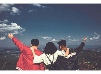 This image shows 3 friends on a hill top